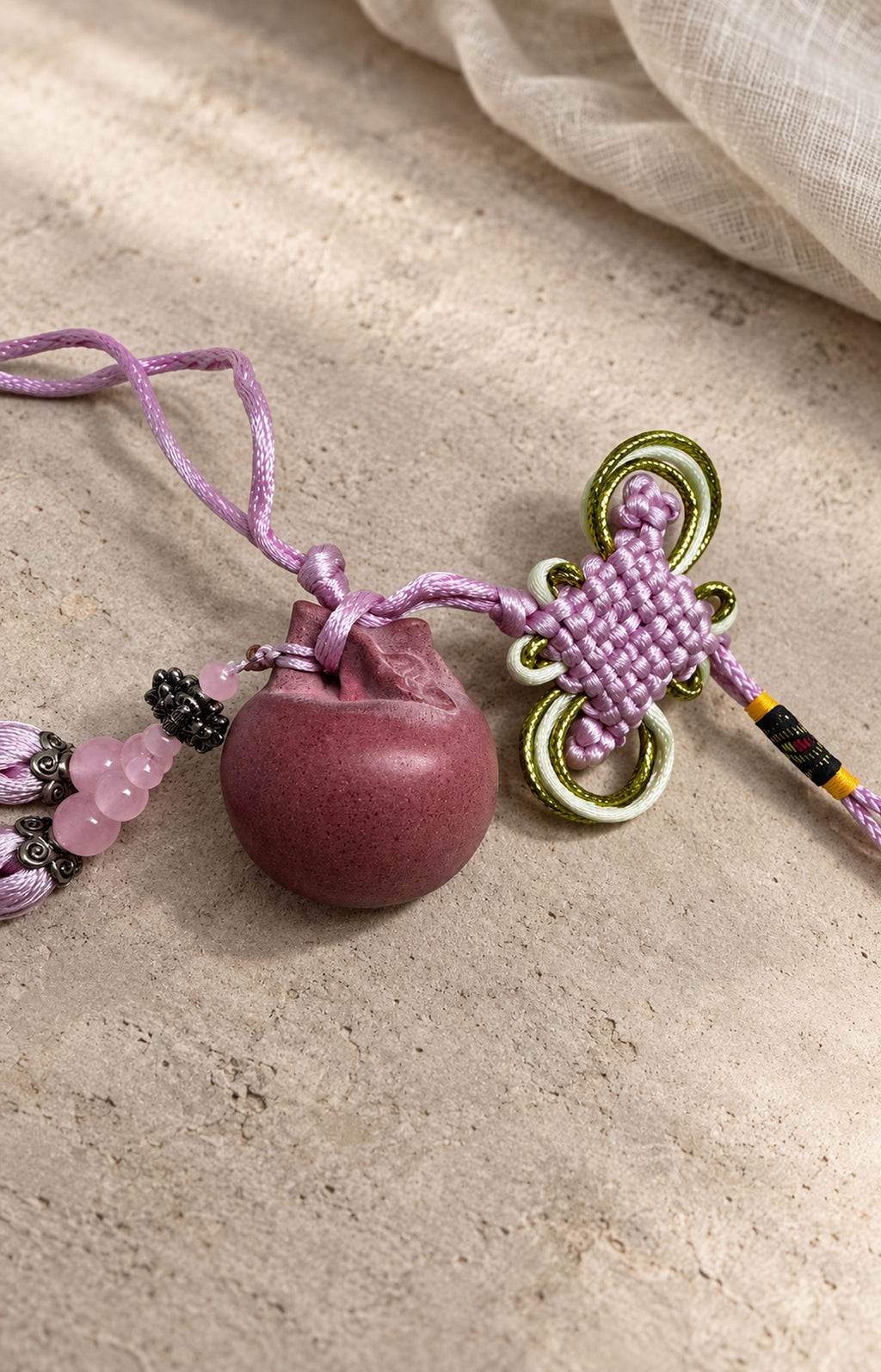Pink hanging charm with decorative knot and tassels