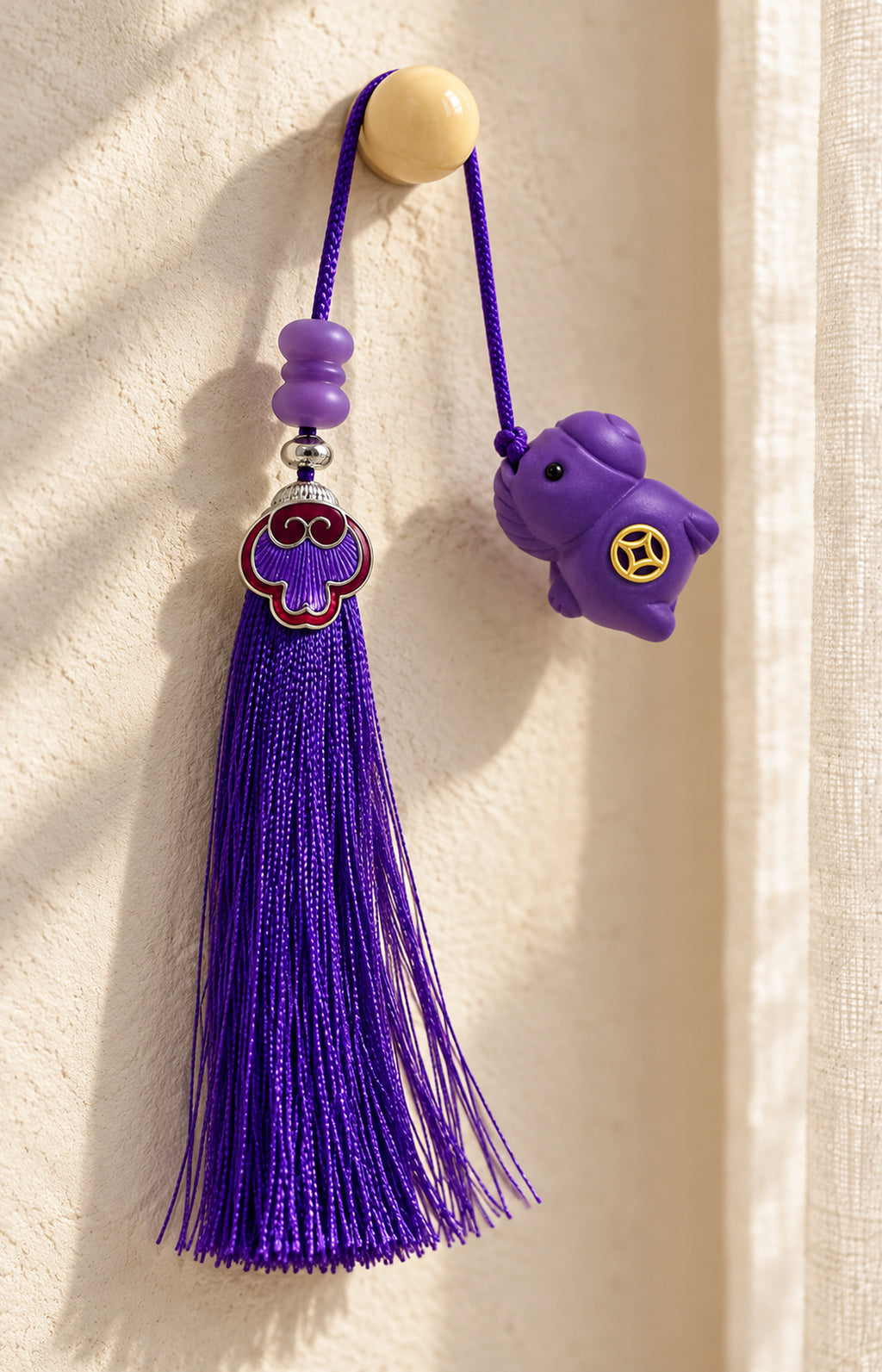 Violet Play NUWARIA purple scented charm hanging beside a window