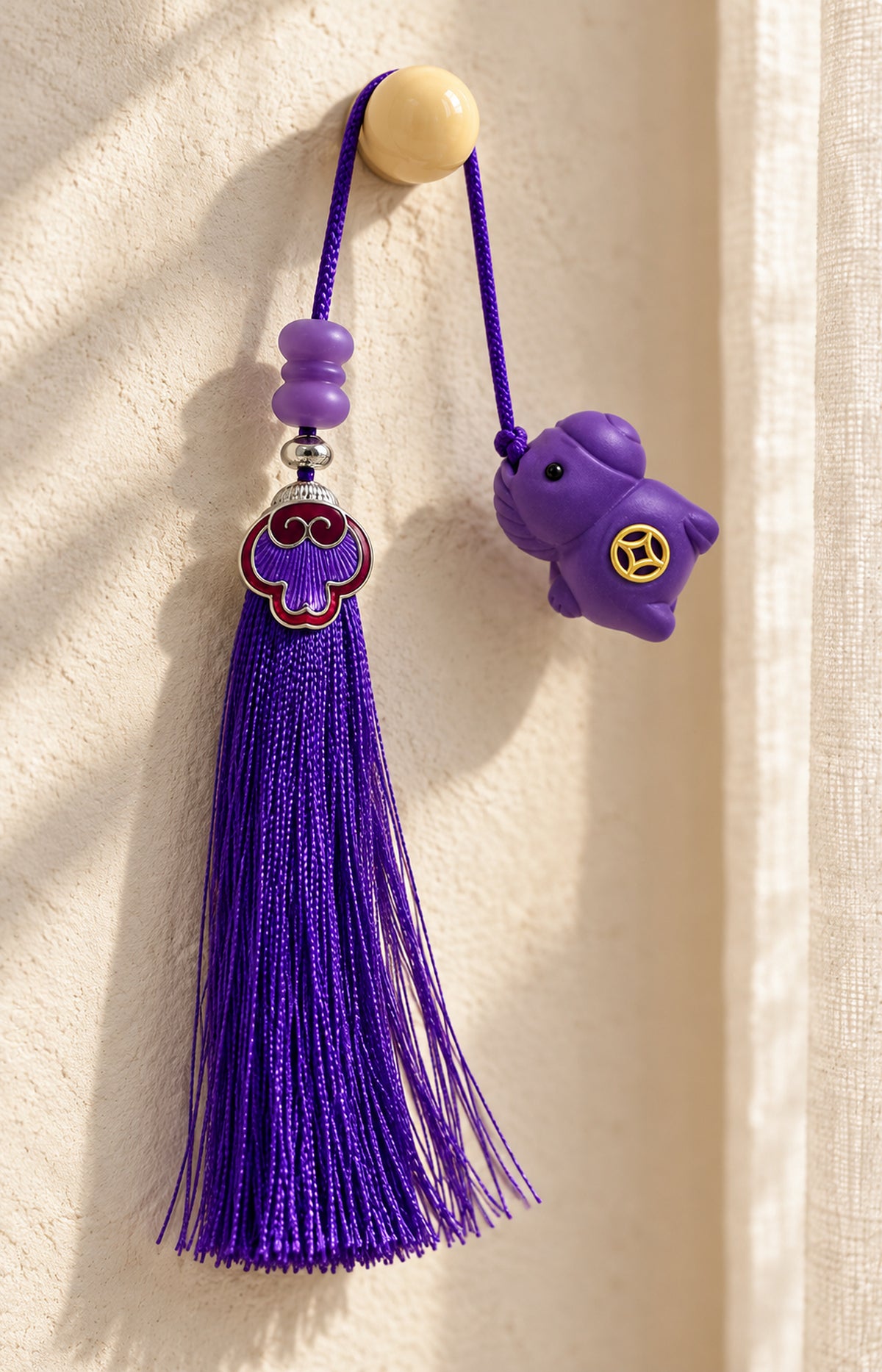 Violet Play NUWARIA purple scented charm hanging beside a window