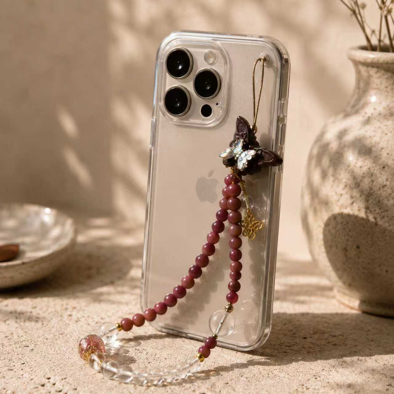 Botanical phone scent charm attached to a phone case